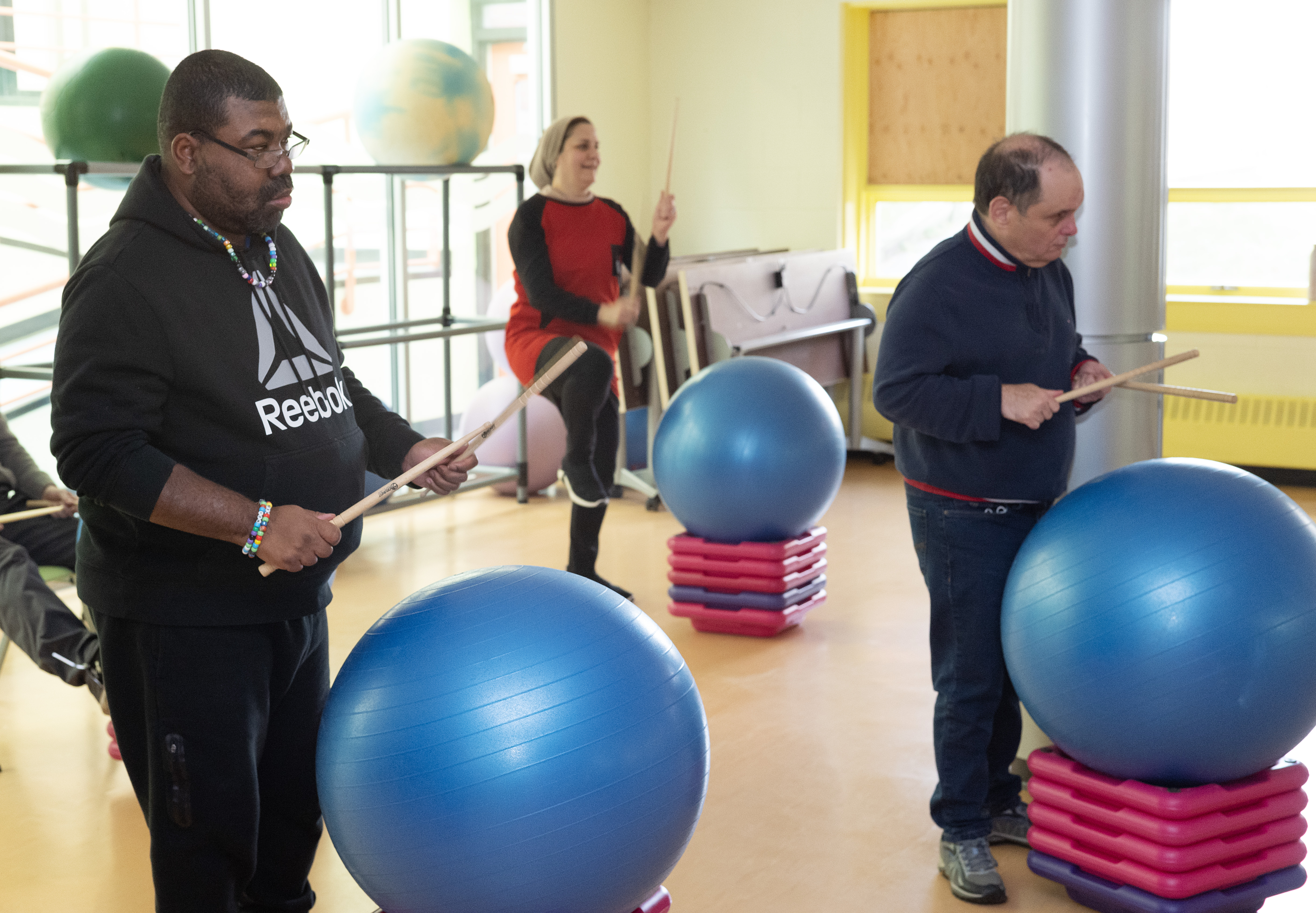 people playing drums with yoga balls