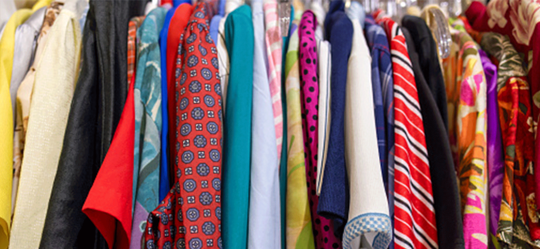 colourful clothing hanging closely together on a display rack