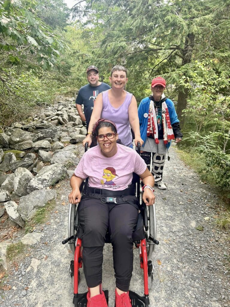 group of people hiking on a trail together, enjoying the outdoors.