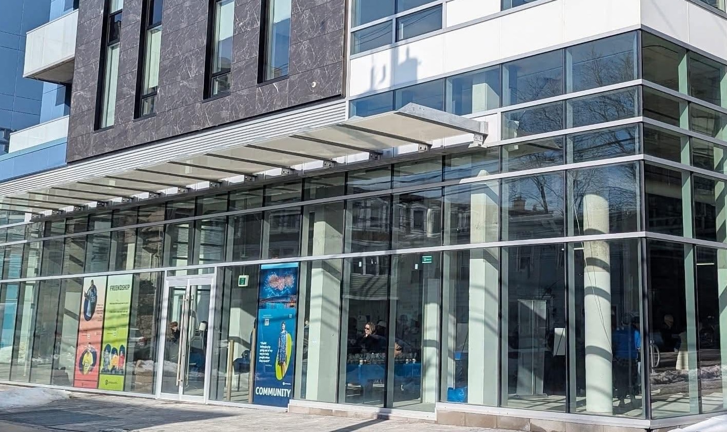 downtown Halifax city building with colourful banners in the main floor window