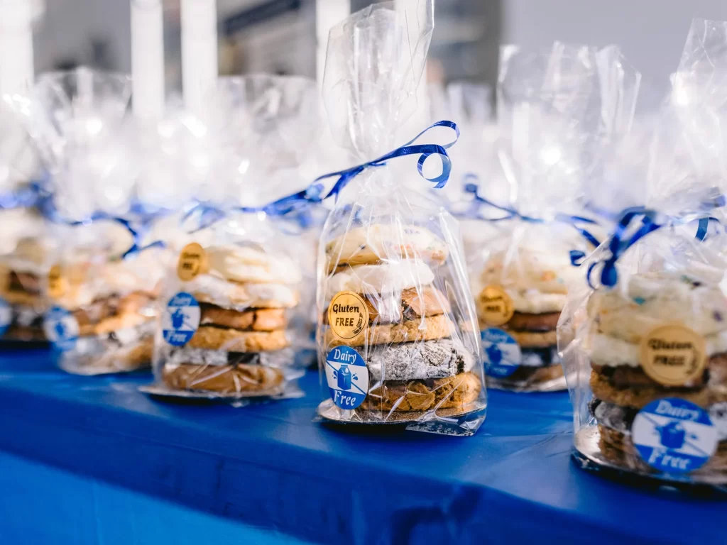 display of packaged cookies across a table covered in a blue tablecloth