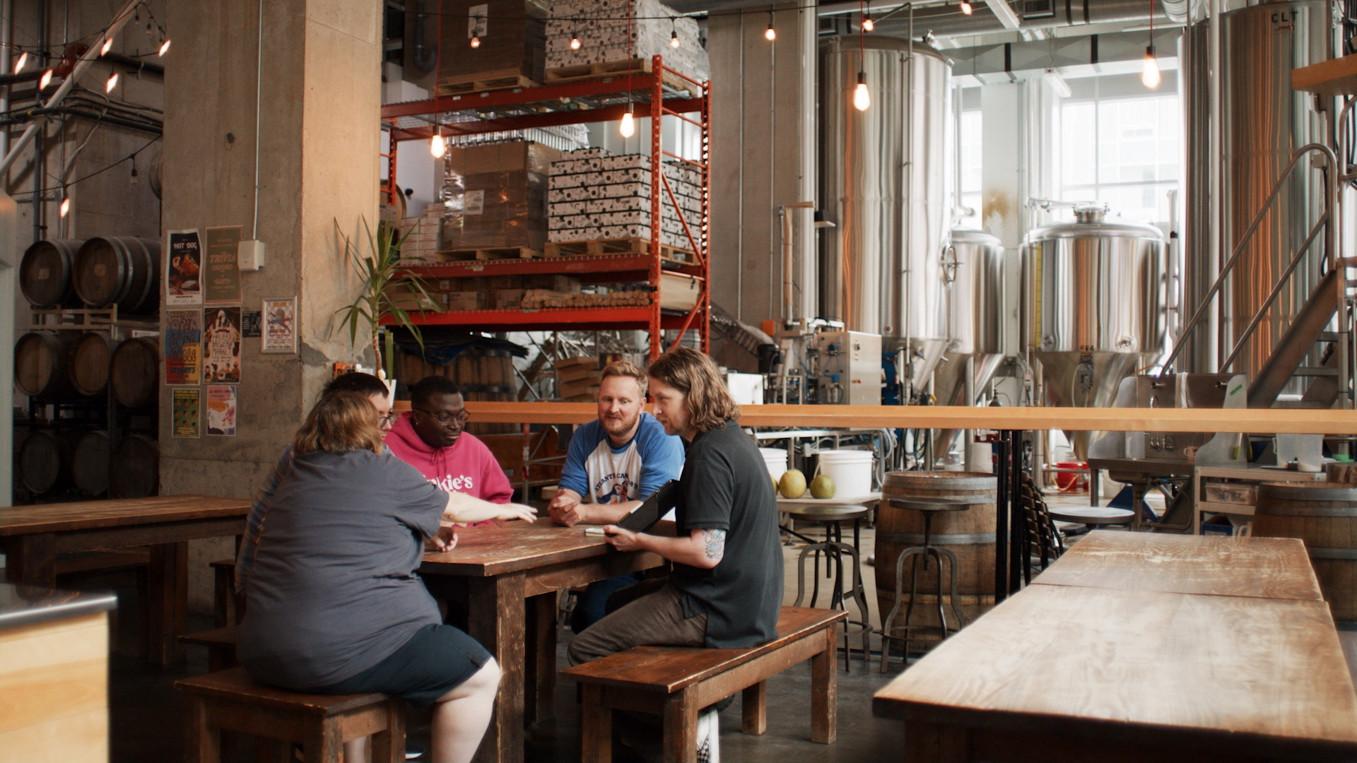 Two Crows Brewing Company has team meeting with 5 people sitting around a table