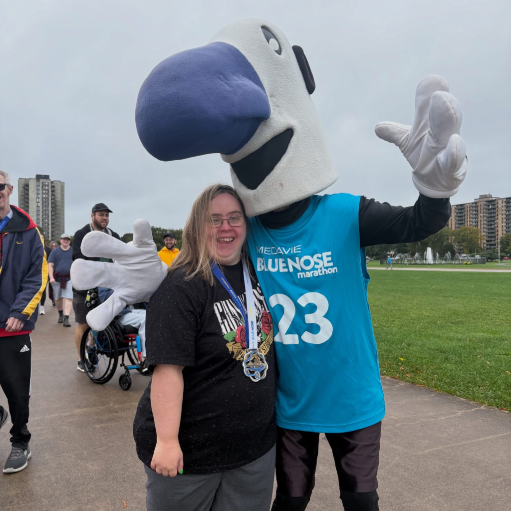 Myles the mascot pose with a participant at the annual fundraiser event.