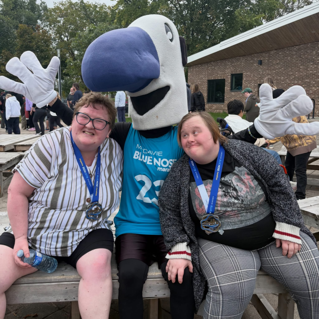 Myles the mascot pose with a participants at the annual fundraiser event.